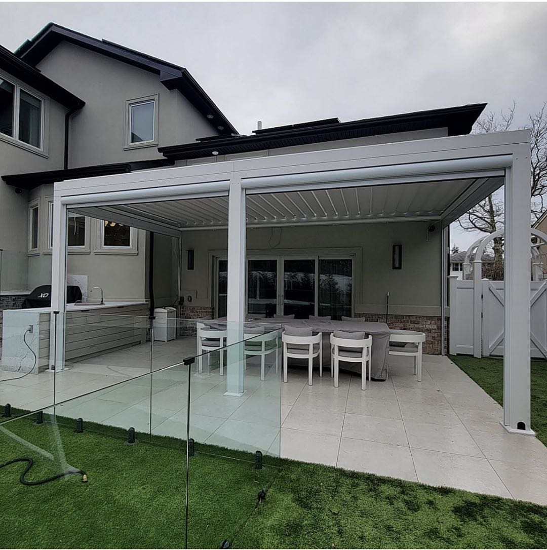 White motorized pergola with glass walls